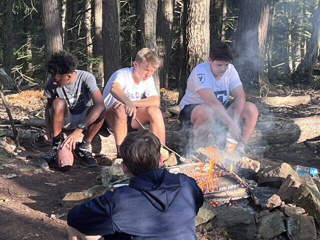 Briggs and classmates around the campfire