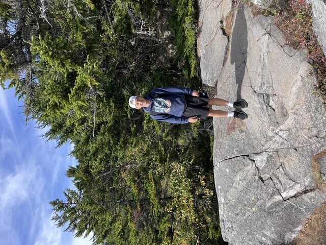 Briggs hiking on a rocky outcrop