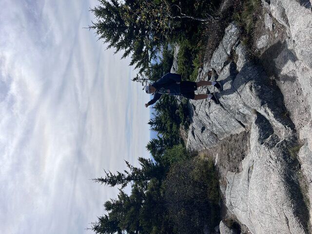 Briggs celebrating at the summit of a hike