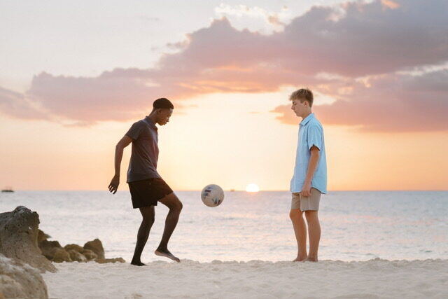 Briggs and his friend playing soccer at sunset