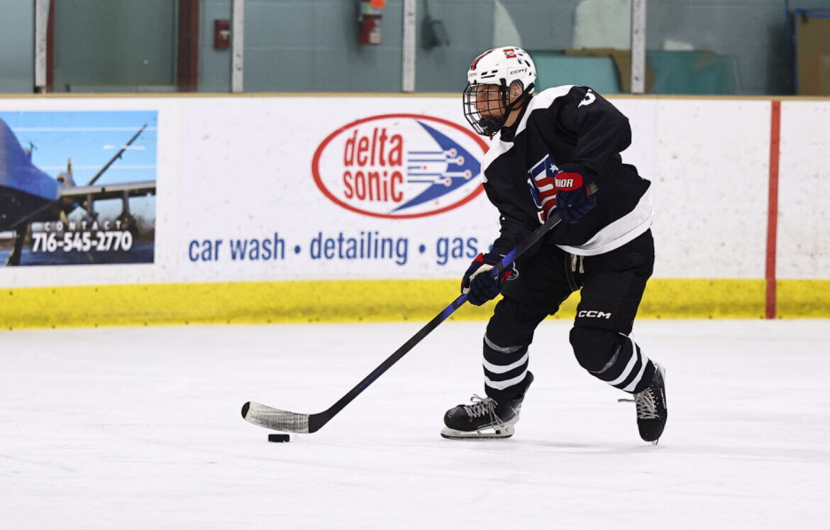 Briggs controlling the puck in a black jersey